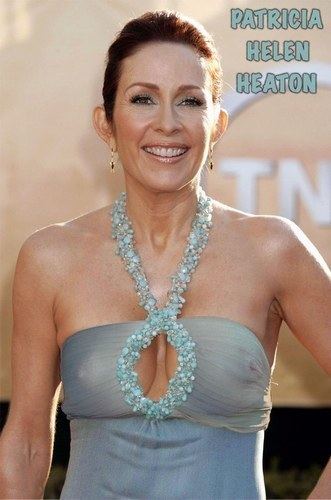 Patricia Heaton wearing earrings and a sexy gown showing her cleavage.