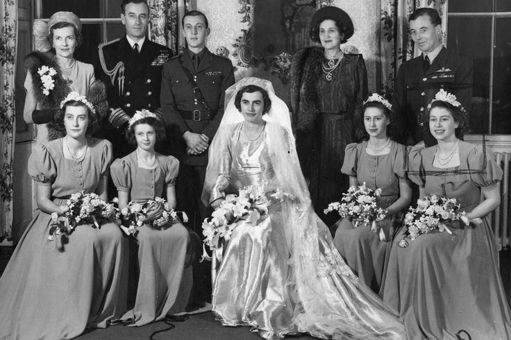 Patricia Knatchbull during her wedding day together with her family. Patricia holding a bouquet of flowers, wearing a gown, and a veil.