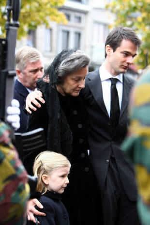 Countess Anna Maria d'Udekem d'Acoz with a sad face, wearing a black scarf and dress with his son Charles wearing a black suit and tie and with a little blonde hair girl during the funeral of Patrick D'Udekem D'Acoz.