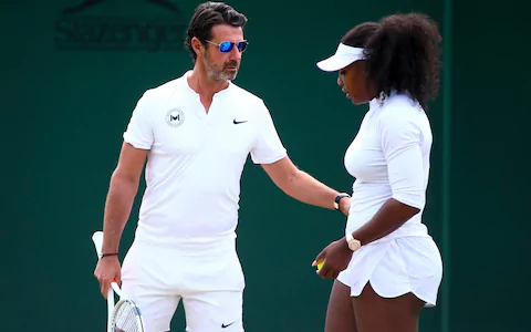 Patrick Mouratoglou wearing a watch, sunglasses, a white polo shirt, white shorts, while holding a racket together with Serena Williams wearing a watch, white cap, white shirt, and white shorts while holding a tennis ball.