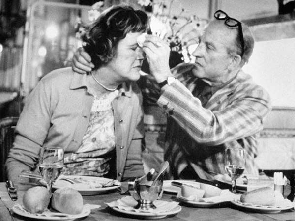 Paul Cushing Child and Julia Child sitting together with a portion of food in front of them