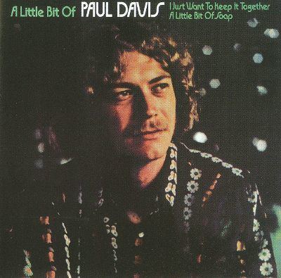 Poster of Paul Davis with curly hair and wearing a floral polo shirt.