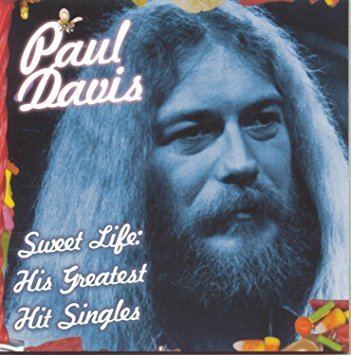 Poster of Paul Davis, with long hair, with a mustache and beard.