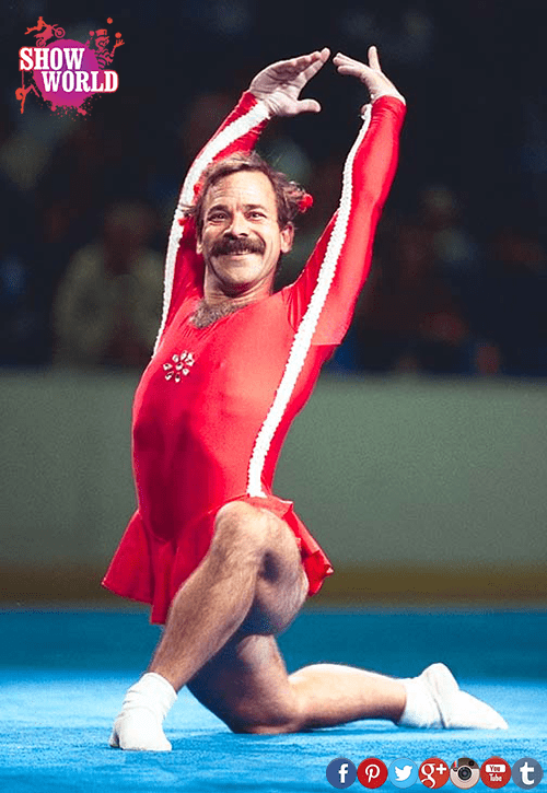 Paul Hunt wearing white and red skirted leotard as he performs a floor exercise