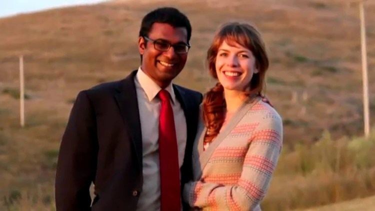 Paul Kalanithi smiling while wearing a black coat, white long sleeves, and red necktie while Lucy Kalanithi wearing a pink and gray blazer
