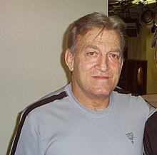 Paul Orndorff smiling while wearing black and gray shirt