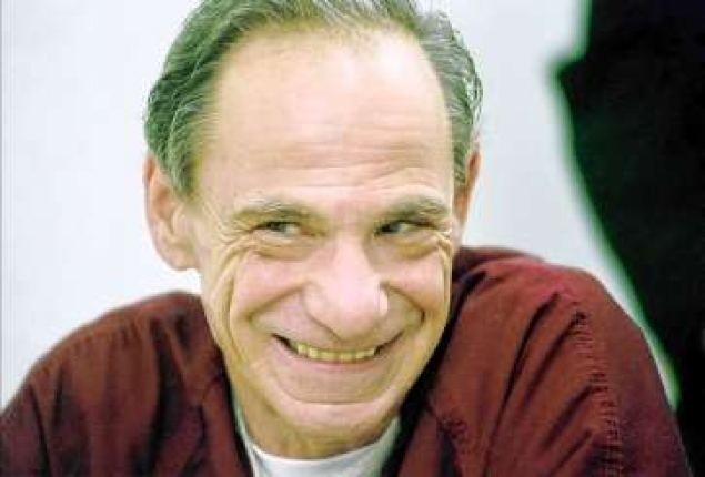 Henry Hill smiling while wearing brown long sleeves