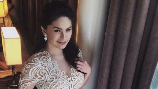 Pauleen Luna with long wavy hair, wearing earrings and a white wedding gown.