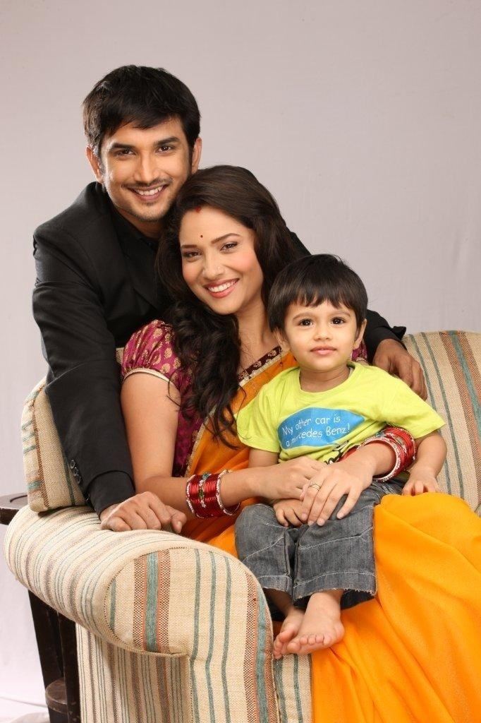Sushant Singh Rajput and Ankita Lokhande smiling with the toddler sitting on her lap