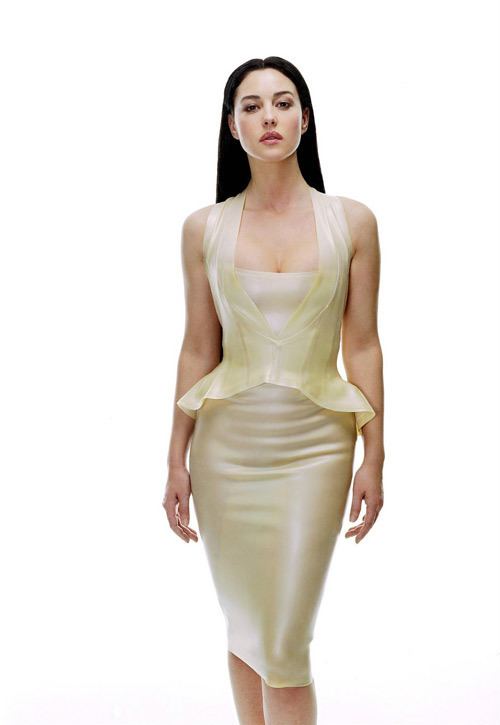 Monica Bellucci as Persephone with a fierce look while wearing a cream sleeveless dress