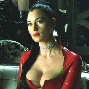Monica Bellucci as Persephone looking afar while wearing a chocker and red long sleeve blouse showing some cleavage