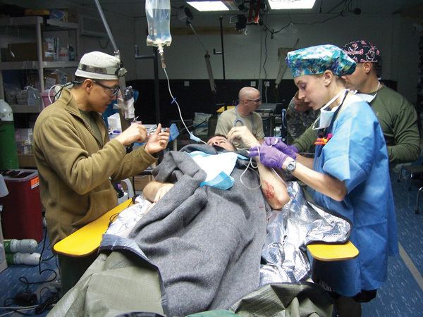 Peter M. Rhee operating a patient along with other medical personnel.