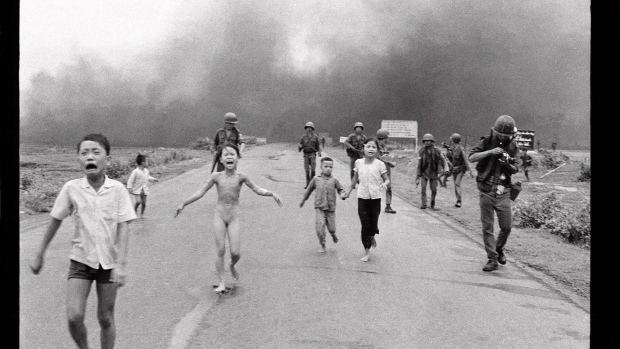 Young Phan Thi Kim Phuc (center left) running down a road naked while crying near Trảng Bàng after a South Vietnam Air Force napalm attack along with other children and soldiers in an old photograph