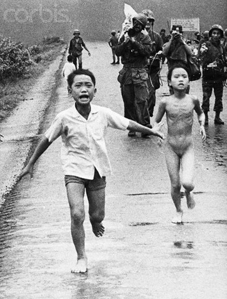Young Phan Thi Kim Phuc (right) running down a road naked while crying near Trảng Bàng after a South Vietnam Air Force napalm attack along with other children and soldiers in an old photograph