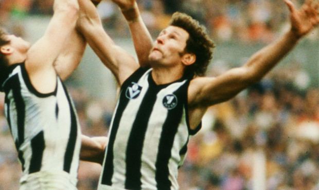 Phil Carman playing football and wearing a black and white sleeveless shirt