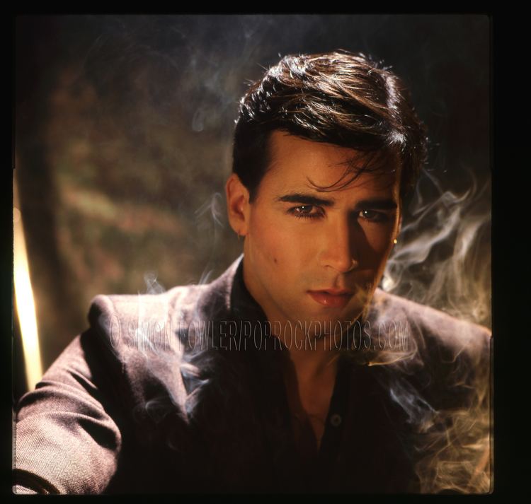 Philip Oakey with his fierce look wearing a black coat during his pictorial