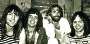 Philip Taylor Kramer smiling while wearing a striped sando with his bandmates