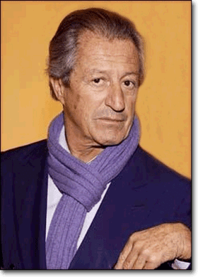 Philippe Junot wearing a blue coat, white long sleeves, and violet scarf
