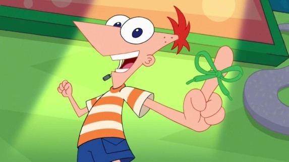 Phineas Flynn smiling while showing his finger with a green ribbon. Phineas with a lapel microphone near his mouth, orange hair, and blue eyes is wearing an orange and light yellow striped t-shirt and blue shorts