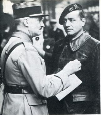 Pierre Armand Gaston Billotte wearing a coat and cap with a man standing on his front wearing a uniform.