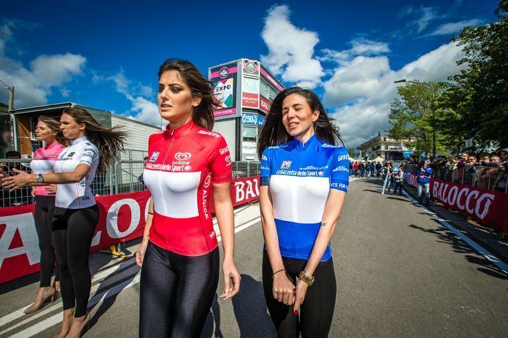 Four Podium girls standing in the street wearing jerseys