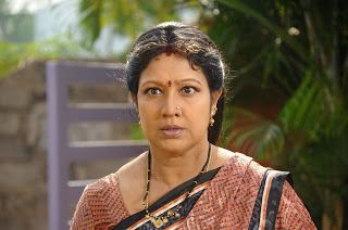 Prabha wearing earrings and a necklace.