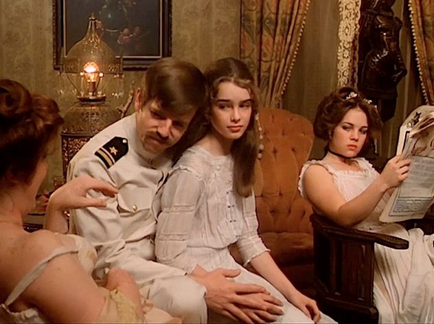 Brooke Shields sitting on top of the lap of C.C. Courtney in Pretty Baby (1978) | movie scene