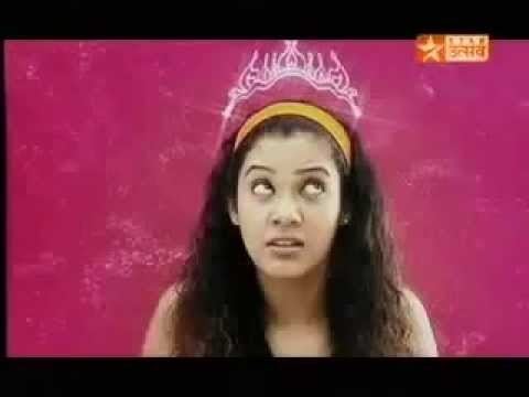Karishma Randhawa as Princess Dollie Suri, looking at the crown on her head while wearing an orange headband in a scene from the 2004 tv series, Princess Dollie Aur Uska Magic Bag