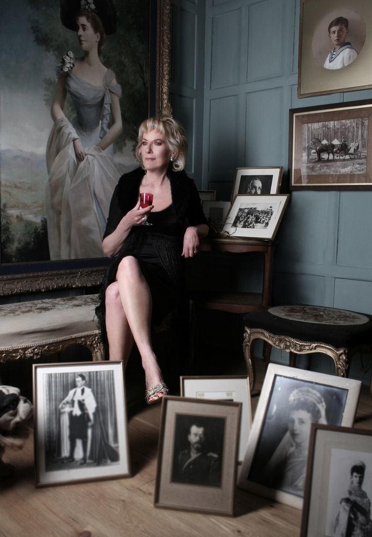 Princess Olga Andreevna Romanoff sitting on a chair while surrounded by pictures and paintings