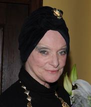 Princess Stephanie of Windisch-Graetz with a tight-lipped smile, wearing a black headdress, a necklace, and a black dress.