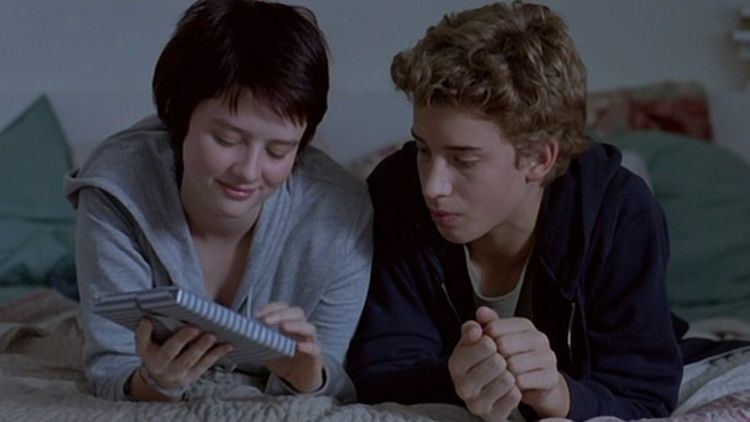 Pauline Étienne as Delphine and Jonas Bloquet as Jonas talking in bed in a scene from Private Lessons, 2008.