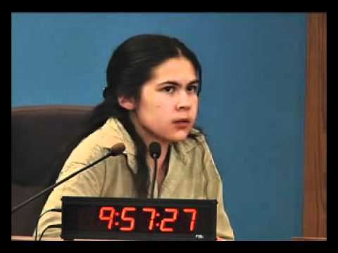 Promethea Pythaitha testifies at the coroner's inquest for Livingston shooting while wearing a beige jacket
