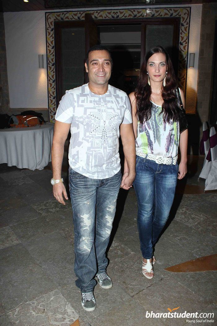 Puru Raajkumar smiling and wearing a shirt and jeans together with his wife, Koraljika Grdak with long wavy hair and wearing a sleeveless shirt and blue jeans.