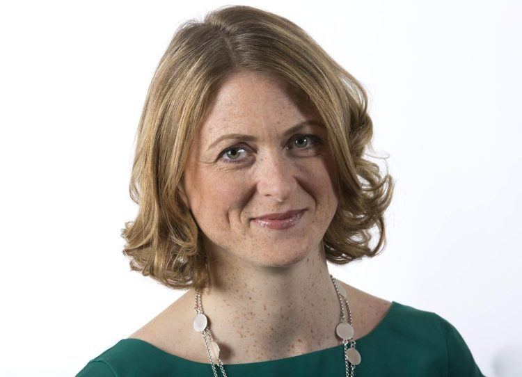 Rachel Burden in white background wearing a green sleeve