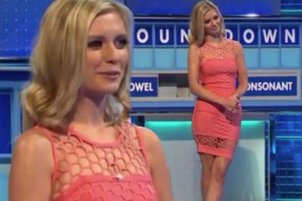 Rachel Riley (left) is smiling, has blonde hair, and wears a pink-like fishnet dress. On right is also Rachel Riley smiling, both hands holding each other, legs crossed, with a monitor at the back with the word “COUNTDOWN” and a board below with a vowel word on left with piled tile letters, and consonant word with piled tile letters, she is wearing a pink-like fishnet dress.