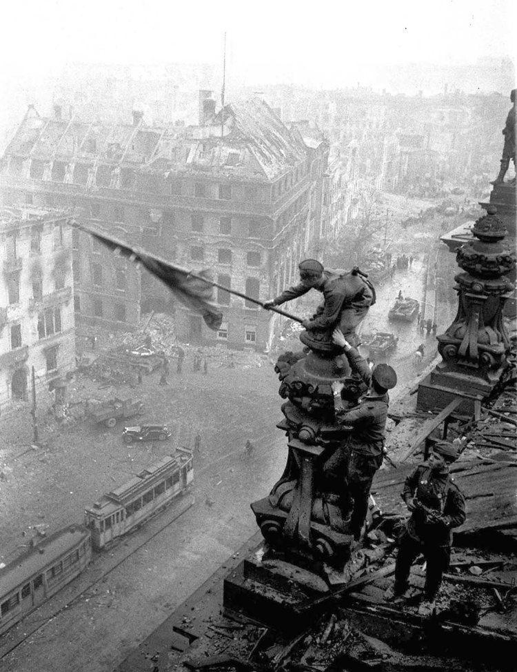 Raising a flag over the Reichstag The Soviet flag over the Reichstag 1945