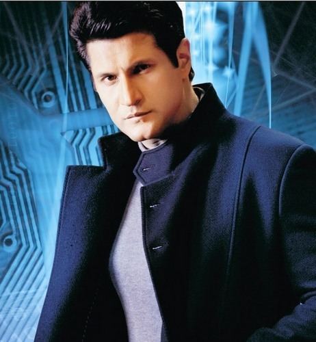 Rajiv Makhni wearing a black blazer and gray shirt