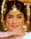 Rajshree smiling, with a nose piercing, wearing earrings, bracelets, and a necklace.