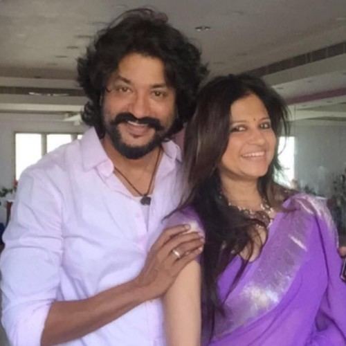 Ramji wearing a pink long sleeves with a woman
