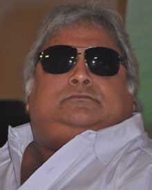 Ramkumar Ganesan wearing sunglasses, and a white polo shirt.
