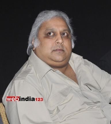 Ramkumar Ganesan with white hair and wearing a polo shirt.