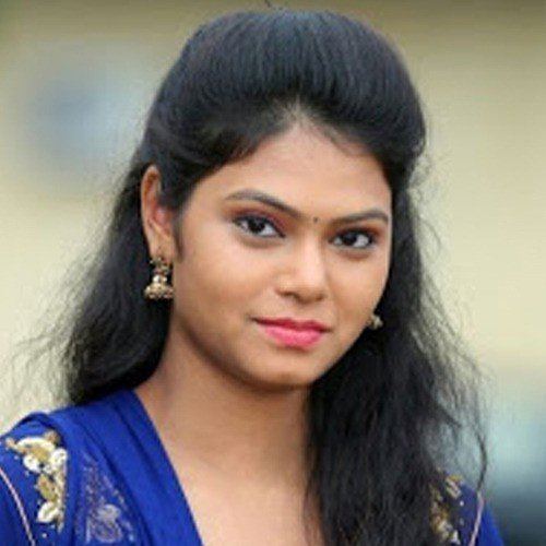 Ramya Behara smiling, with black hair, wearing a blue Indian dress.