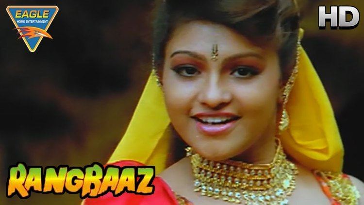 Movie poster of Rangbaaz, a 1996 Indian Hindi-language action film starring Shilpa Shirodkar with a smiling face, wearing a yellow veil, earrings, and necklace.