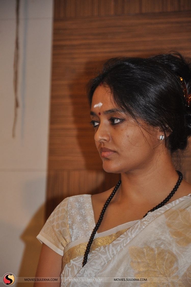 Ranjitha wearing a dress and black necklace