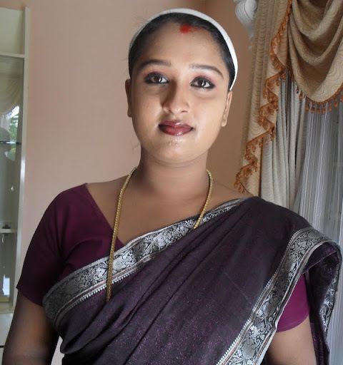 Rasna wearing an Indian outfit, necklace and white headband