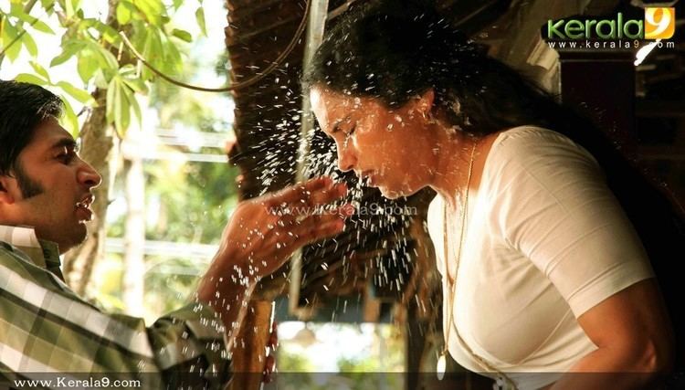 Sreejith Vijay splatter water on Shweta Menon's face in a movie scene from the 2011 erotic drama film Rathinirvedam