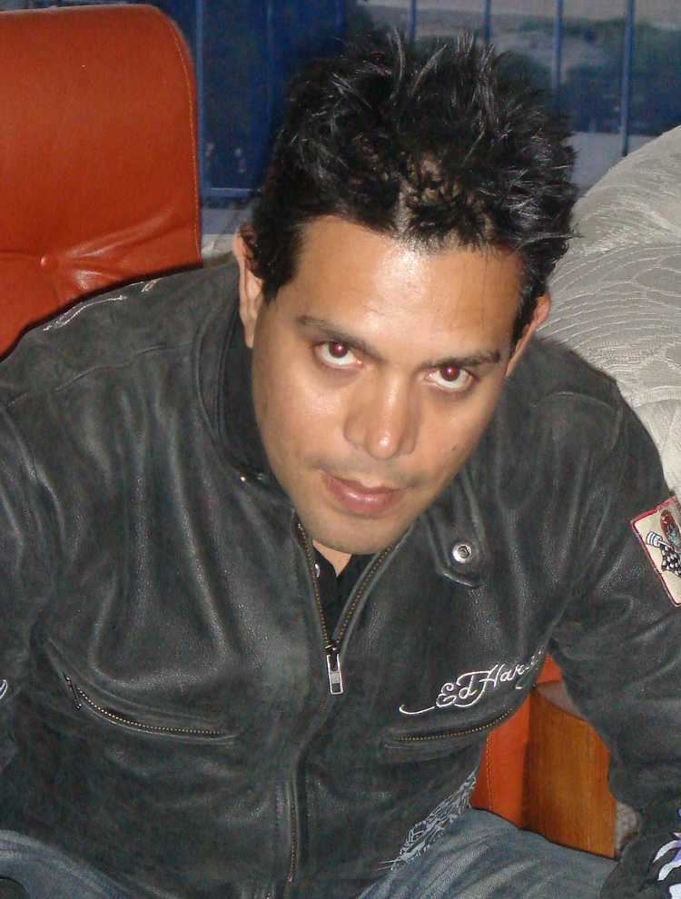 Raul Julia-Levy with a serious face while wearing a black jacket and denim pants
