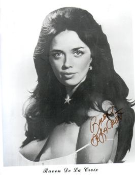 Portrait of Raven De La Croix with an autograph while wearing a sleeveless top