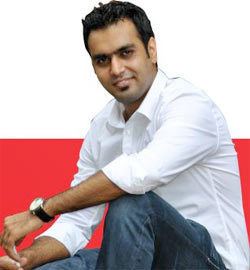 Ravinder Singh smiling while wearing white long sleeves, pants, and wristwatch