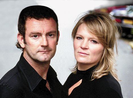Ray Kluun and his wife Judith van de Klundert with serious faces and both are wearing black tops.